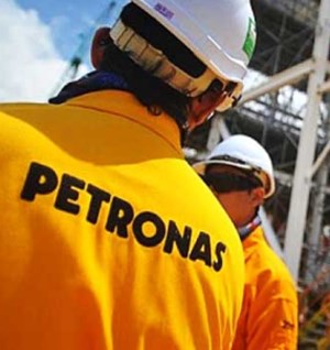 PETRONAS workers in yellow suits and white helmets