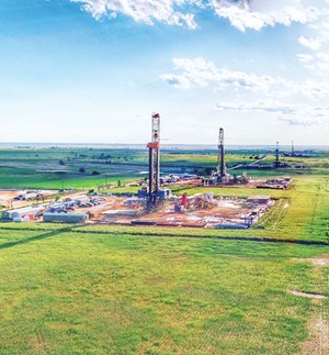 Fig. 2. A row of rigs at work as part of Encana’s STACK cube development strategy. Image: Encana Corp.