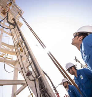 Aramco employees working on a rig to advance the energy transition