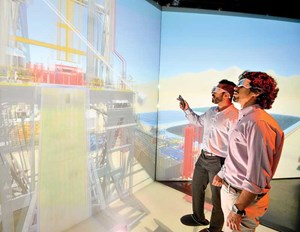 Two Aramco professionals looking at a digital transformation display