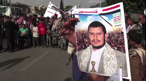 A Yemeni protestor holds a portrait of rebel leader Abdul Malik al-Houthi.