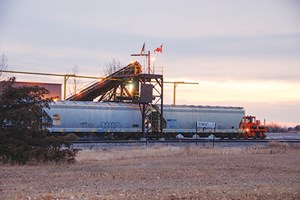 At sun-up on a cold November 2011 morning, frac sand is unloaded from covered hopper cars in Bowbells, N.D., just south of the Canadian border. Photo by the author.