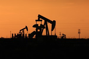 silhouette of a drilling rig in the Permian Basin
