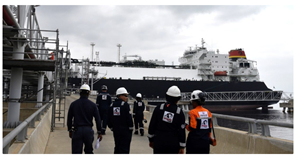 worker&#x27;s gathering around an LNG vessel to celebrate Angola LNG&#x27;s 400th cargo delivery